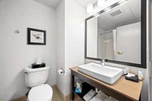 a bathroom with a white toilet and a sink at Independence Stay Hotel & Suites in Marinette +36 photos