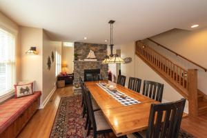 a dining room with a table and a fireplace at Bear Foot by Railey Vacations in Oakland