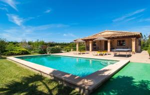 a swimming pool in front of a villa at Ca Na Neus Pollenca in Pollença