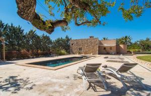 a patio with two chairs and a swimming pool at Es Triquet in Binissalem