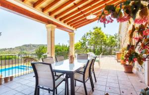 a patio with a table and chairs and a pool at Turixant Dalt in El Port de la Selva