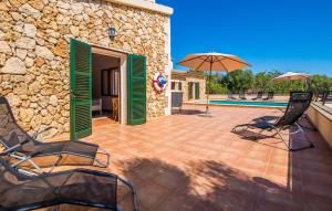 a patio with chairs and an umbrella and a pool at Can Baldo in Sencelles +44 photos