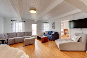 a living room with furniture and a flat screen tv at Le Toit Rouge - 3457 in Saint-Férréol-les-Neiges