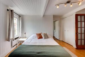 a bedroom with a large bed with a green blanket at Le Toit Rouge - 3457 in Saint-Férréol-les-Neiges +16 photos