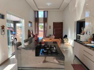 a kitchen with a black counter top and a table at Casa Condomínio Ninho Verde II in Pardinho +15 photos