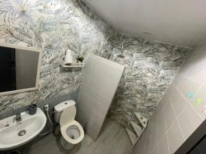 a bathroom with a toilet and a sink at summer house berber in Tamraght Ouzdar +155 photos