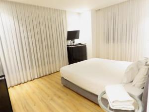 a hotel room with a bed and a chair in it at THE white lotus in Eilat +18 photos