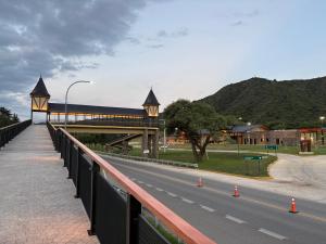 a bridge over a road next to a street at Dos Osos in Villa General Belgrano