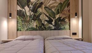 a bedroom with a bed with a painting on the wall at HOTEL RST. PADORNELO in Padornelo +157 photos