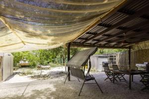 awning over a patio with a table and a piano at Edem private camping in Análipsis