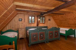 a bedroom with two beds in a wooden cabin at Adršpach chalupa in Adršpach