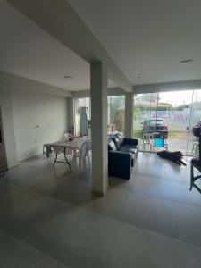 a living room with a couch and a table at Casa 2 quartos a 2 quadras do mar nova in Matinhos