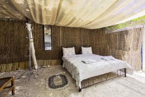 a bedroom with a bed and a tripod in it at Edem private camping in Análipsis +19 photos