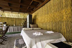 a bedroom with a bed with two towels on it at Edem private camping in Análipsis