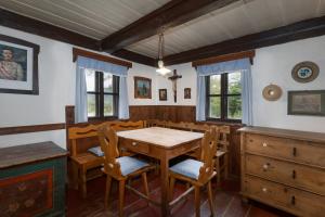 a dining room with a wooden table and chairs at Adršpach chalupa in Adršpach