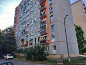 a tall building with a car parked in front of it at Small Apartman in Pécs