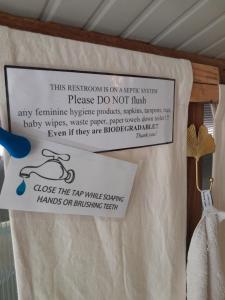a sign that says this restroom is on a sterile system please do not flush at A tiny sea home in the wilderness in Vis