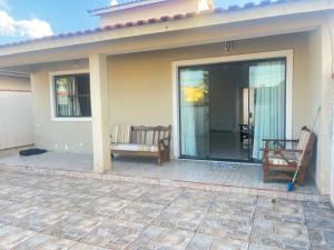a screened in porch of a house with two chairs at Casa ilha comprida perto da praia in Ilha Comprida