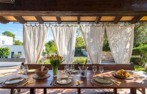 a table with glasses and plates of food on it at Estrella De Son Serra in Son Serra de Marina