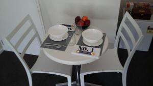 a small white table with a no sign on it at Jan's Boutique B & B Suite in Christchurch +16 photos