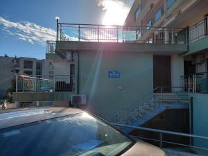 a car parked in front of a building with a balcony at Sea View in Topola