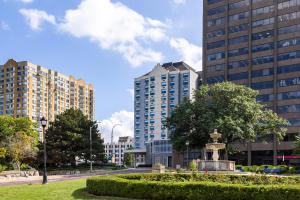 a park with a statue in front of tall buildings at Holiday Inn Express Windsor Waterfront by IHG in Windsor