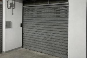 a metal garage door in a building at Home Jocy Spacious 3 Bed rooms Apartment with private Parking Ideal for Groups in Castellammare di Stabia +26 photos