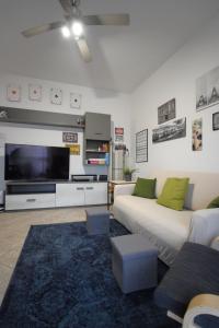 a living room with a couch and a large tv at La Casa di Dante Bologna in Sala Bolognese