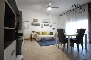 a living room with a table and a couch at La Casa di Dante Bologna in Sala Bolognese