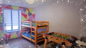 a childs room with two bunk beds and a chess board at Aux P'tits Cabris in Lahayville