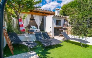a group of chairs and a table in a yard at Casa Gema in El Port de la Selva