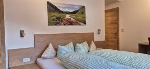 a bedroom with a bed and a picture on the wall at Apart Antonius in Pfunds