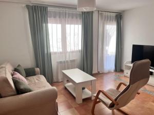 a living room with a couch and a table at Navarubia in Navacerrada