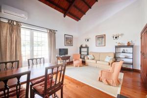 a living room with a table and a couch at Quinta da Alcaidaria Mor in Ourém