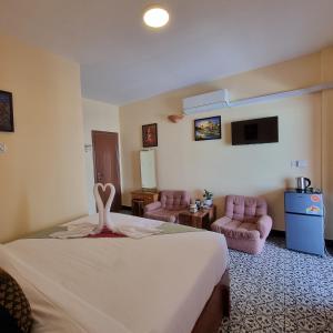 a hotel room with a bed with a towel on it at STAY SWEET in Phnom Penh +151 photos