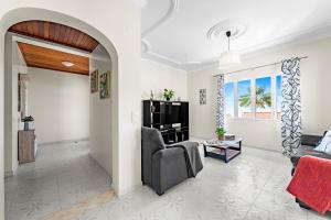 a living room with a couch and a tv at Cumbres Villa in Funchal