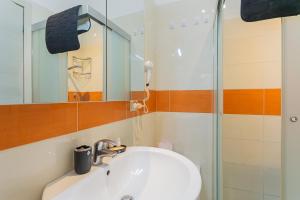 a bathroom with a sink and a shower at Il borgo incantato in Bitonto