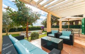 a patio with blue furniture and an umbrella at Sa Copinya in Cala Bona