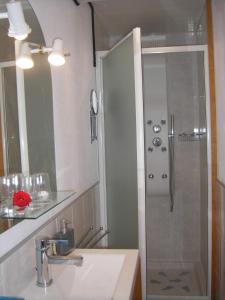 a shower with a glass door in a bathroom at Au Fil de l'Eau in La Ronde +18 photos