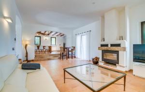 a living room with a white couch and a fireplace at Kiana in Santa Eugenia