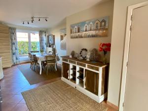 a living room with a table and a dining room at Charming Duplex in Knokke-Heist