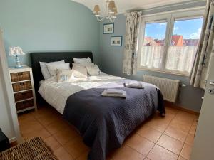 a bedroom with a bed with two towels on it at Charming Duplex in Knokke-Heist
