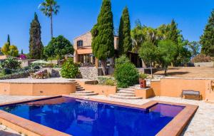 a house with a swimming pool in front of a house at S'alzinar Gran in Artá