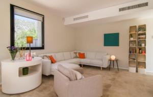 a living room with white furniture and a window at Ternelles in Pollença