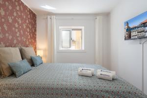 a bedroom with a bed with two pillows on it at Authentic Porto Home by HostWise in Porto
