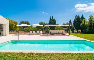 a swimming pool in a yard with a patio at Ternelles in Pollença