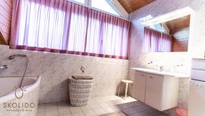 a bathroom with a tub and a sink at Holidayapartment Kirchweg, Glis in Brig +22 photos