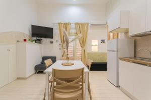 a small kitchen with a table and chairs in a room at Il borgo incantato in Bitonto +14 photos