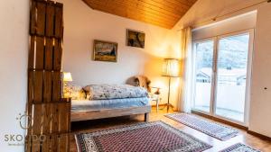 a bedroom with a bed and a sliding glass door at Holidayapartment Kirchweg, Glis in Brig