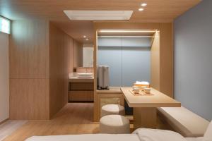 a small bathroom with a sink and a bed at 하로스테이 신사점 in Seoul +45 photos